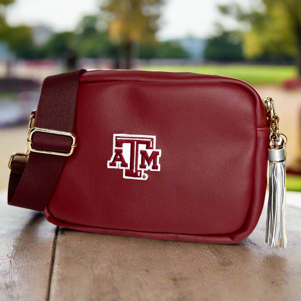 Maroon handbag with a logo on a white background